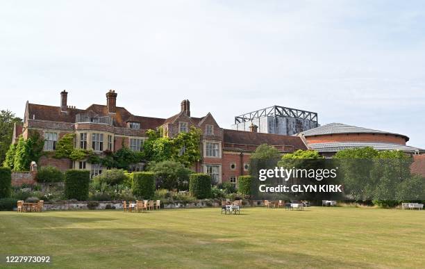 The Manor House and Opera House auditorium at Glyndebourne are pictured in the summer sunshine in southern England on August 8, 2020.