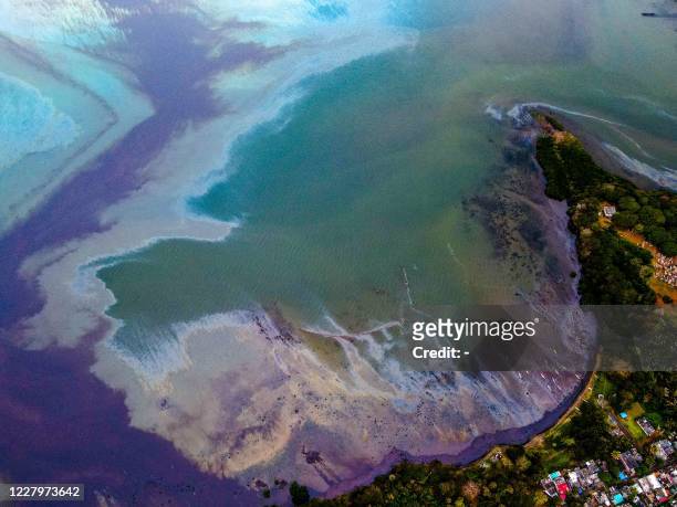 This aerial view taken on August 6, 2020 shows a large patch of leaked oil from the vessel MV Wakashio, belonging to a Japanese company but...