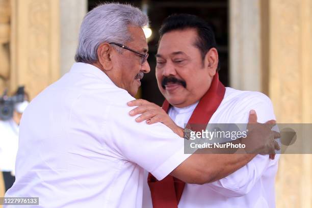 Sri Lankan president Gotabaya Rajapaksa greets and receives blessings after handing over the appointment documents to his brother, former president,...