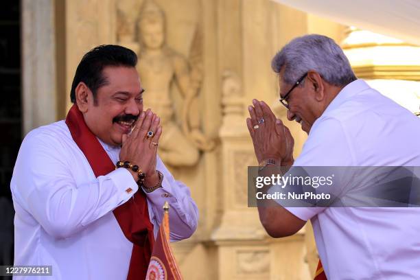 Sri Lankan president Gotabaya Rajapaksa greets after handing over the appointment documents to his brother, former president, Mahinda Rajapaksa who...