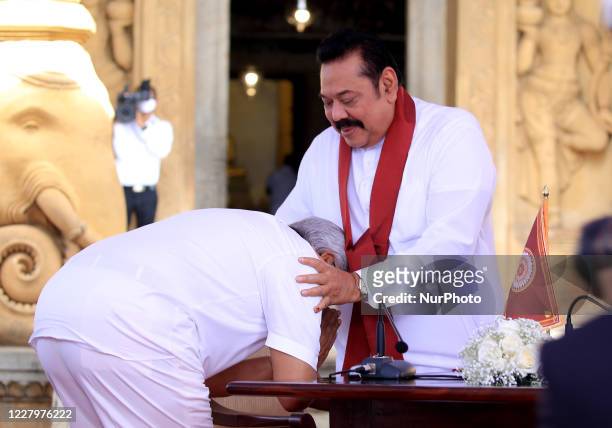 Sri Lankan president Gotabaya Rajapaksa receives blessings after handing over the appointment documents to his brother, former president, Mahinda...