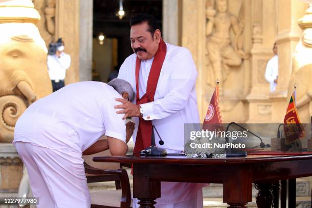 Sri Lankan president Gotabaya Rajapaksa receives blessings after handing over the appointment documents to his brother, former president, Mahinda...