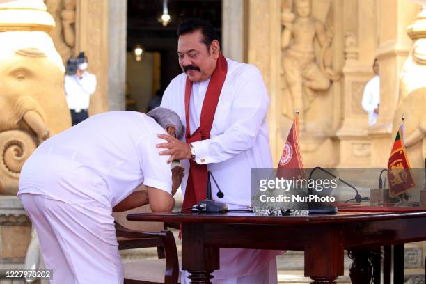 Sri Lankan president Gotabaya Rajapaksa receives blessings after handing over the appointment documents to his brother, former president, Mahinda...
