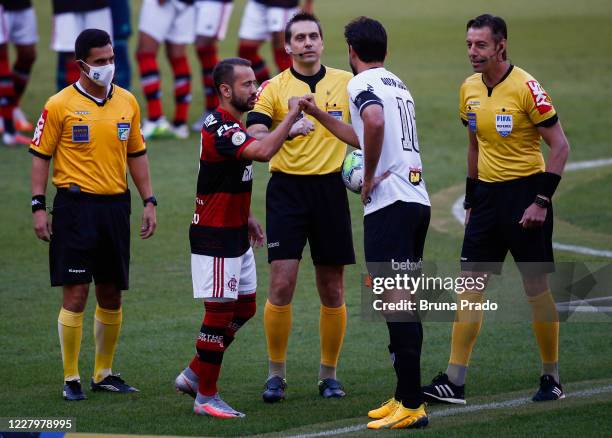 Everton Ribeiro of Flamengo and Igor Rabello of Atletico MG greet each other prior to the match between Flamengo and Atletico MG as part of the first...