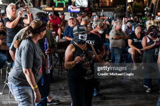 Maggie Zepeda, center, dances as she watches a concert at the Full Throttle Saloon during the 80th Annual Sturgis Motorcycle Rally in Sturgis, South...