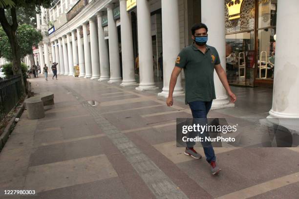 People cover their face with masks to curb the spread of coronavirus pandemic at Connaught Place in New Delhi, India on August 9, 2020. With 64,399...