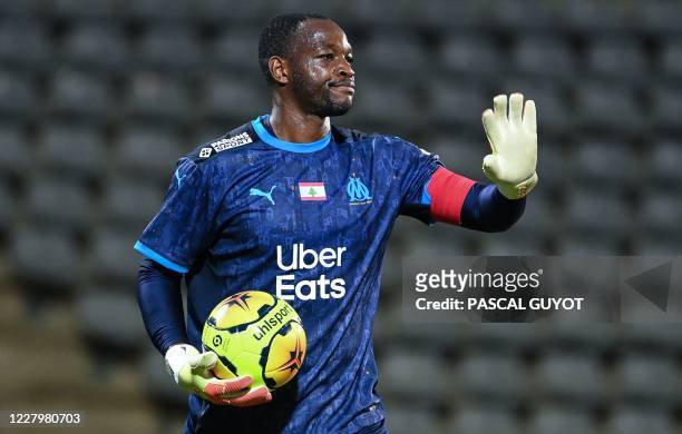 Marseille's French goalkeeper Steve Mandanda reacts during the French friendly football match between Nimes Olympique and Olympique de Marseille at...