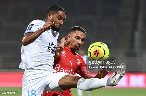 Nimes' French defender Yassine Benrahou vies for the ball with Marseille's French defender Jordan Amavi during the French friendly football match...