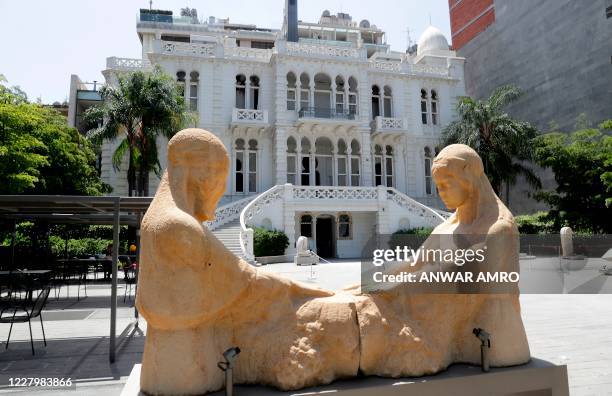 This picture taken on August 8, 2020 shows a view of "The Weeping Women sculpture, depicting a Christian and Muslim woman mourning together in the...