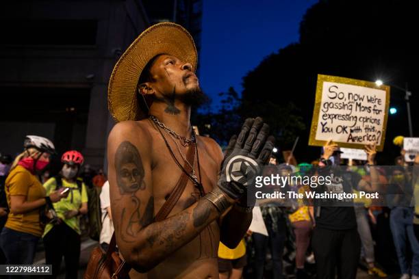 Man prays during the nightly protest in front of the Mark O. Hatfield U.S. Courthouse on July 21, 2020 in Portland, Ore. The federal police response...