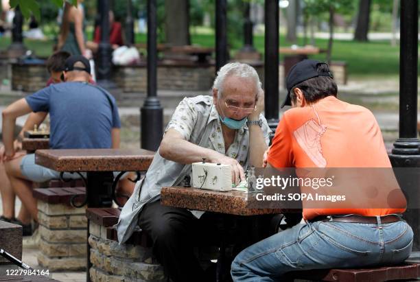 Man wearing a face mask as a preventive measure plays chess in a park in downtown Kiev. The number of the COVID-19 coronavirus cases has risen...