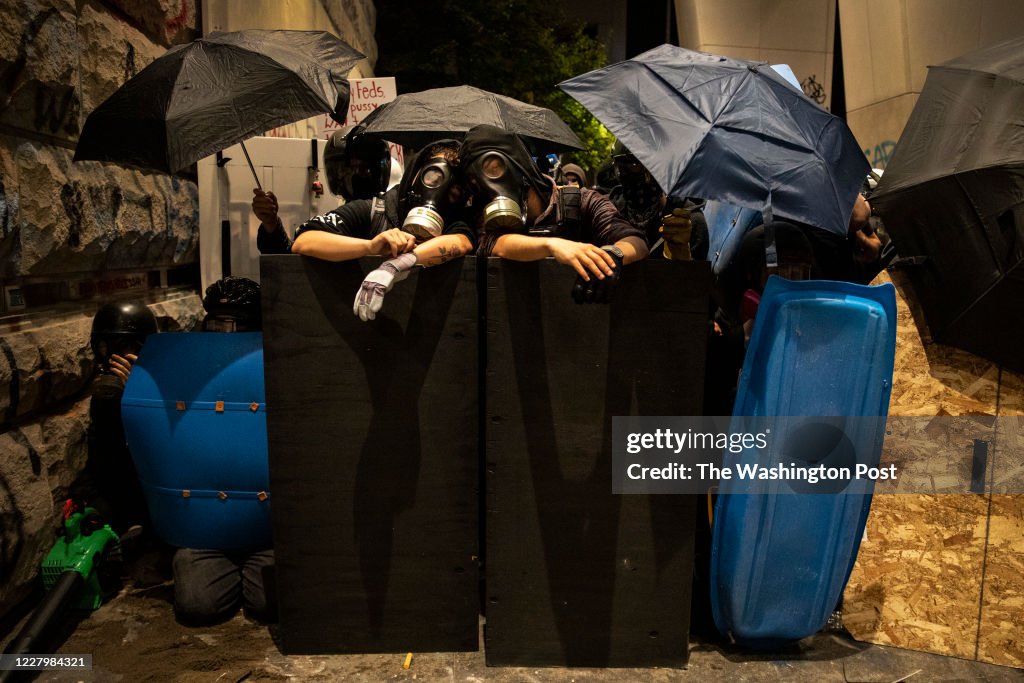 PORTLAND, OR - JULY 21: Protesters with gas masks are ready for