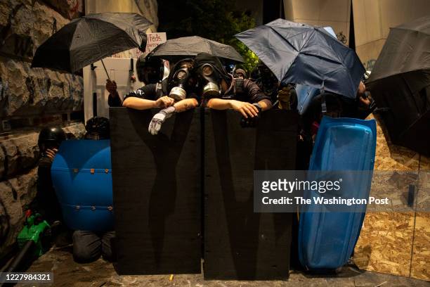 Protesters with gas masks are ready for the next battle in front of the Mark O. Hatfield U.S. Courthouse on July 21, 2020 in Portland, Ore. The...