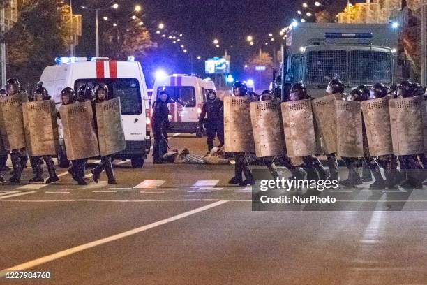 Riot police keep custody of some protester on the floor during a public unrest in the streets of Minsk, Belarus, on August 9, 2020 at the end of the...