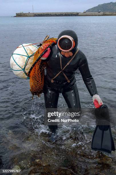 Pearl divers landing after catch the seafood near Jeju Sea in Jeju Island, South Korea, on August 24, 2003.