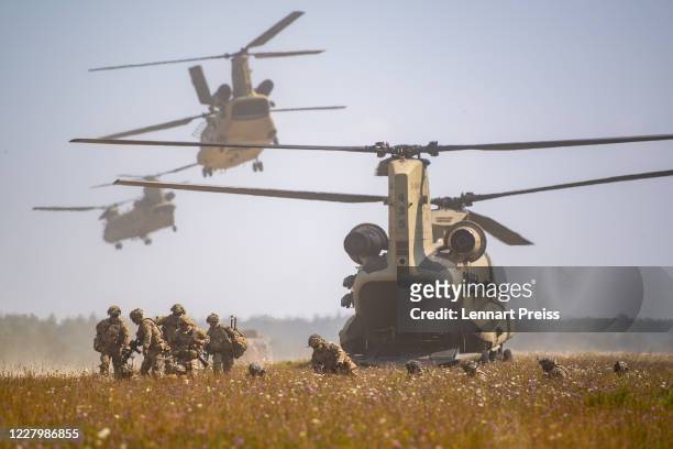 Troops of the U.S. 173rd Airborne Brigade disembark from Chinook CH-47 helicopters while participating in the Saber Junction 20 military exercises at...