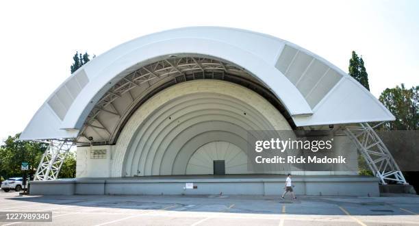 Man walks past the Bandshell, a staple feature of the CNE every year with musical and cultural acts which usually occur during the day. As with much...