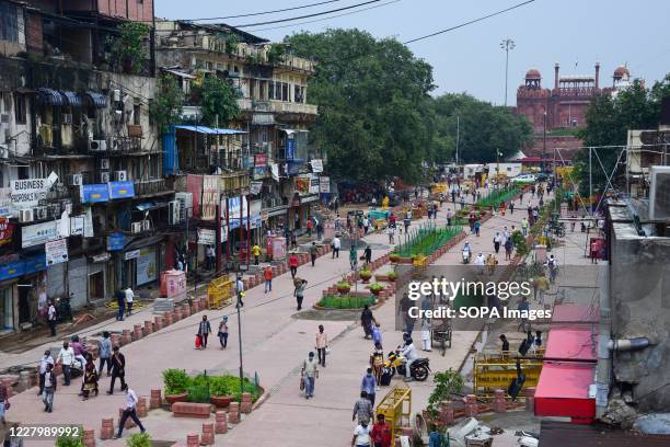 People walking on a newly constructed stretch in front of the Red Fort which also connect to Fatehpuri at Chandni Chowk amid ongoing renovation works...