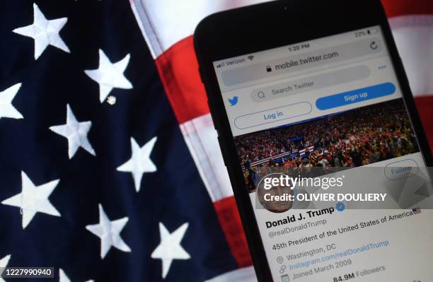 In this photo illustration, the Twitter account of US President Donald Trump is displayed on a mobile phone on August 10 in Arlington, Virginia. -...