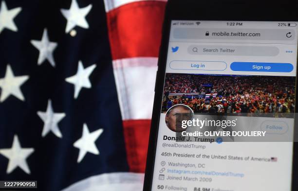 In this photo illustration, the Twitter account of US President Donald Trump is displayed on a mobile phone on August 10 in Arlington, Virginia. -...