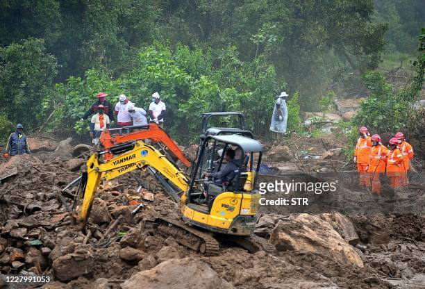 Rescue workers search for missing people at a landslide site caused by heavy rains in Pettimudy, in Kerala state, on August 10, 2020. - At least 43...