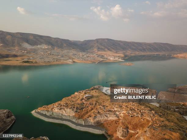 This picture taken on August 3 shows the Il?su Dam separating the newly constructed Hasankeyf town and the remains of the ancient town of the same...