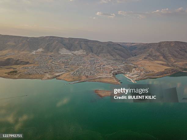 This picture taken on August 6 shows the Il?su Dam separating the newly government built Hasankeyf town and the remains of the ancient town of the...