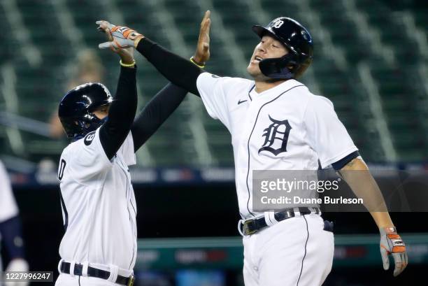JaCoby Jones of the Detroit Tigers celebrates with Harold Castro of the Detroit Tigers after hitting an inside-the-park home run against the Chicago...