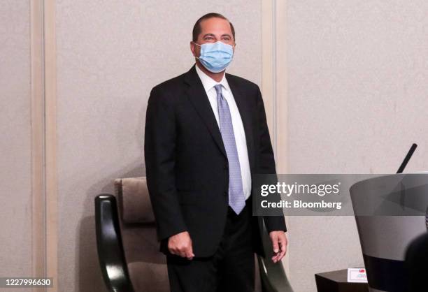 Alex Azar, secretary of Health and Human Services , left, wears a protective mask while attending a news conference in Taipei, Taiwan, on Tuesday,...