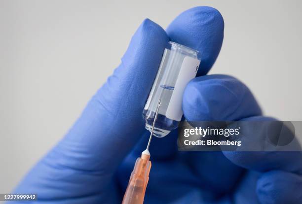 Medical worker draws liquid from a vial with a syringe in this arranged photograph taken at the Chaika Clinic in Moscow, Russia, on Monday, Aug. 10,...