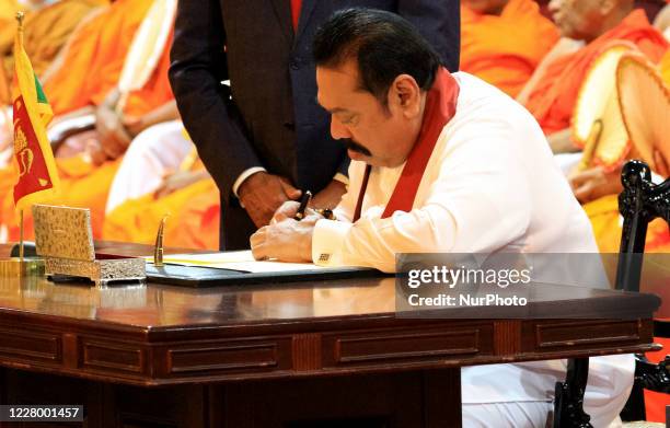 Sri Lankan prime minister Mahinda Rajapaksa signs the official papers to assume duties at prime minister's office, Temple Trees, at Colombo, Sri...