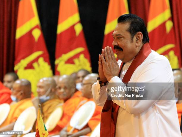 Sri Lankan prime minister Mahinda Rajapaksa greets his supporters before officially assuming duties at his office, Temple Trees, at Colombo, Sri...