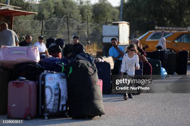 Palestinians wait to cross into Egypt through the Rafah border crossing between Gaza Strip and Egypt after five months of closure as a precautionary...