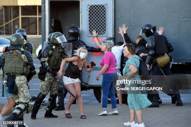 Riot police detain protesters during a rally of opposition supporters, who accuse strongman Alexander Lukashenko of falsifying the polls in the...