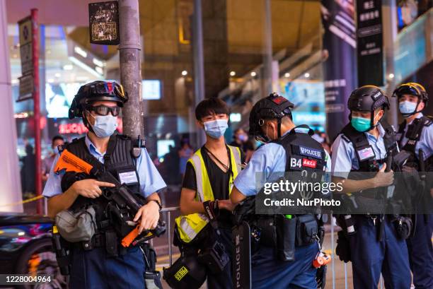 Student journalist is subject to a stop and search by riot police on Portland street in Mongkok on August 11, 20220 in Hong Kong, China.