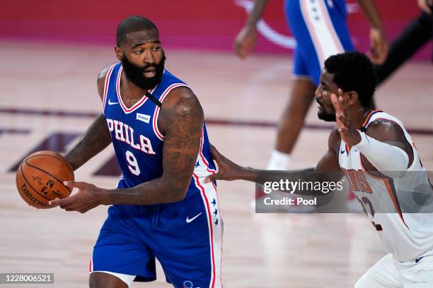 Kyle O'Quinn of the Philadelphia 76ers looks for help as Deandre Ayton of the Phoenix Suns defends during the first half of a NBA basketball game at...