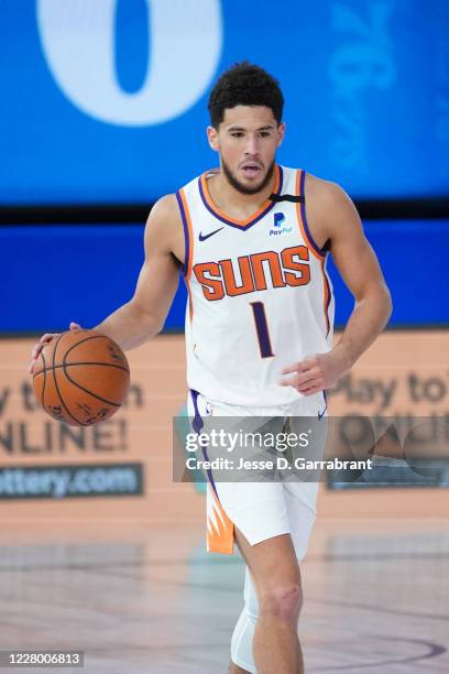 Orlando, FL Devin Booker of the Phoenix Suns handles the ball against the Phoenix Suns on August 11, 2020 at Visa Athletic Center at ESPN Wide World...