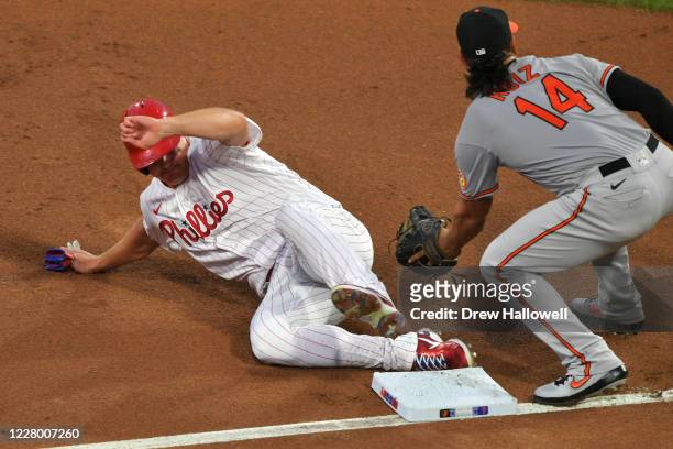 Jay Bruce of the Philadelphia Phillies slides safely into third base under the tag of Rio Ruiz of the Baltimore Orioles at Citizens Bank Park on...