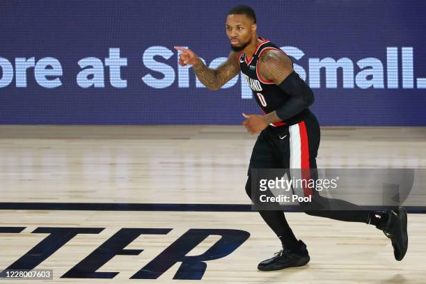 Damian Lillard of the Portland Trail Blazers reacts after making a three point basket during the second half against the Dallas Mavericks at The...