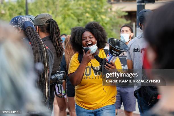 Woman shouts into a megaphone during a rally against Chicago Police violence in the Englewood neighborhood of Chicago, Illinois, on August 11, 2020.