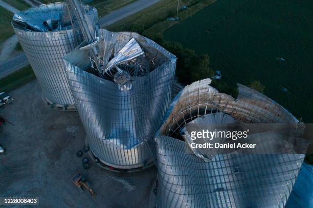 In this aerial image from a drone, damaged grain bins are shown at the Heartland Co-Op grain elevator on August 11, 2020 in Malcom, Iowa. Iowa Gov....