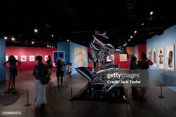 Visitors view various original works by Andy Warhol at the 'Andy Warhol: Pop Art' exhibition at the RCB Galleria on August 12, 2020 in Bangkok,...