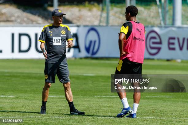 Head coach Lucien Favre of Borussia Dortmund and Jude Bellingham of Borussia Dortmund gesture during day 2 of the pre-season summer training camp of...