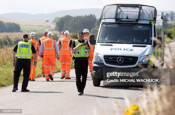 Network Rail engineers and Police officers work near the scene of a train crash by Stonehaven in northeast Scotland on August 12, 2020. - A passenger...