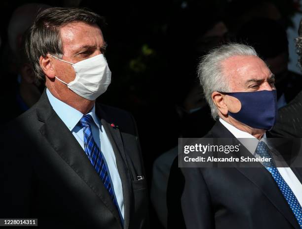 President of Brazil Jair Bolsonaro and Brazil's former President Michel Temer look on during a visit to BASP to accompany the Brazilian delegation's...