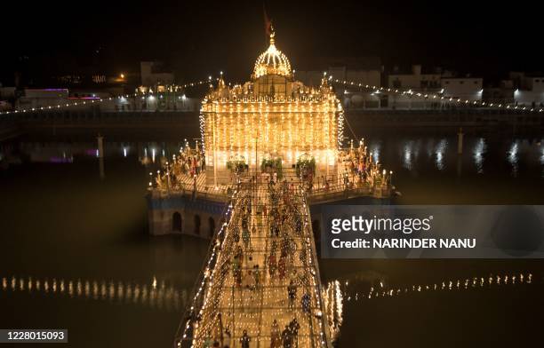 Hindu devotees arrive to pay their respect on the occasion of the 'Janmashtami' festival marking the birth of Hindu God Lord Krishna, at the...
