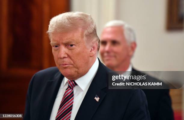 President Donald Trump and US Vice President Mike Pence arrive for the "Getting America's Children Safely Back to School" event in the State Room of...