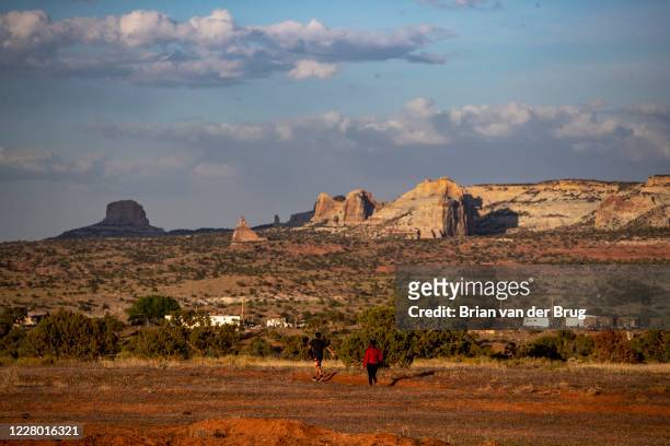 Young people stroll through a field on the Navajo Reservation on Saturday, May 23, 2020 during the 57-hour lockdown in Kaibito, AZ. COVID-19 is...