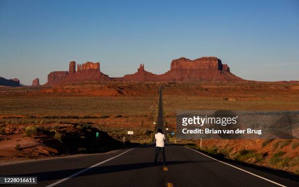 Dawn breaks over sandstone formations as a man takes a photo at popular tourist stop dubbed "Forrest Gump Hill", the spot where the fictional movie...
