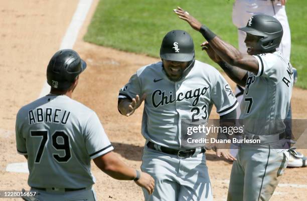 Edwin Encarnacion of the Chicago White Sox celebrates with Jose Abreu and Tim Anderson after they scored against the Detroit Tigers on a double by...